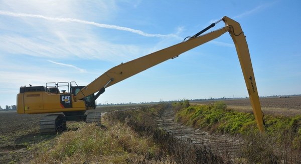 The Cat long reach excavator shapes slopes The Cat long reach excavator shapes slopes