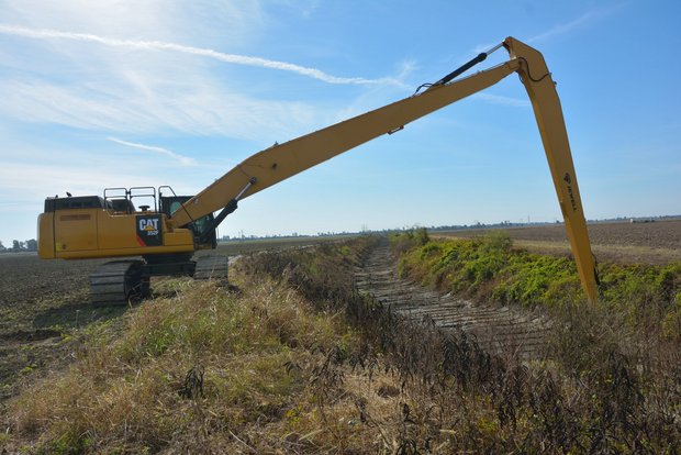 Cat long reach excavator is forming slopes Cat long reach excavator is forming slopes