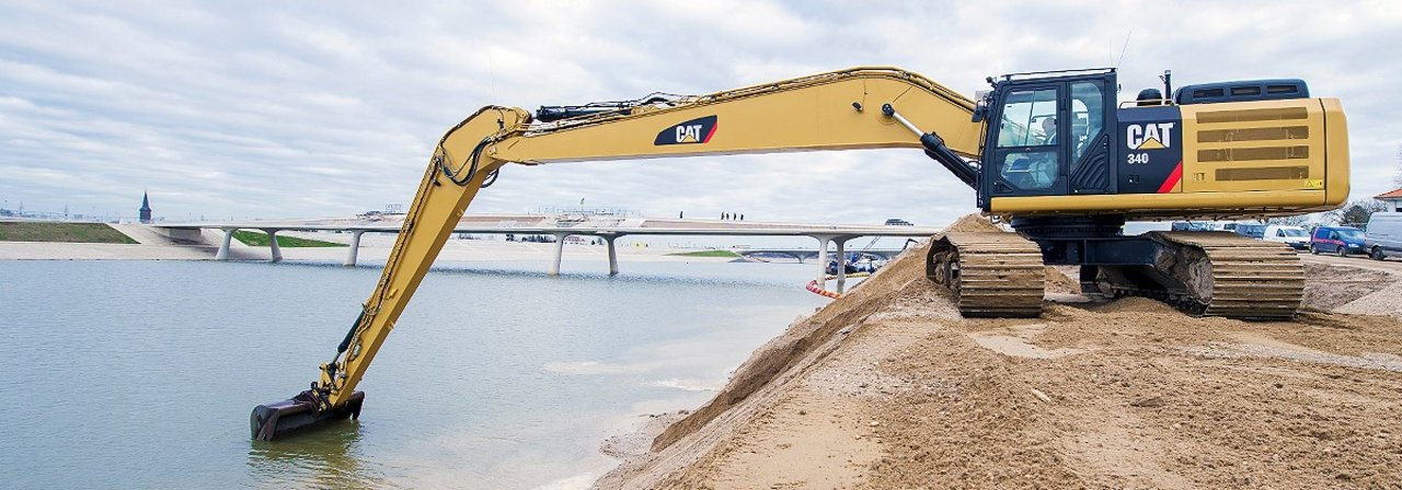 Cat long reach excavator performs digging works Cat long reach excavator performs digging works